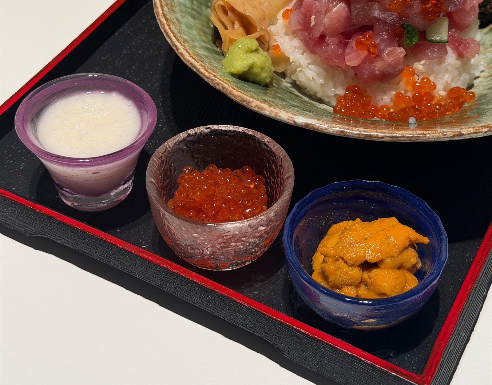 Three Kaisendon bowls lined up on a wooden counter