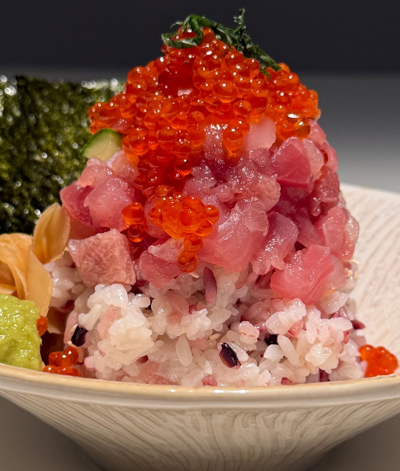 Egg yolk being poured over a Kaisendon bowl