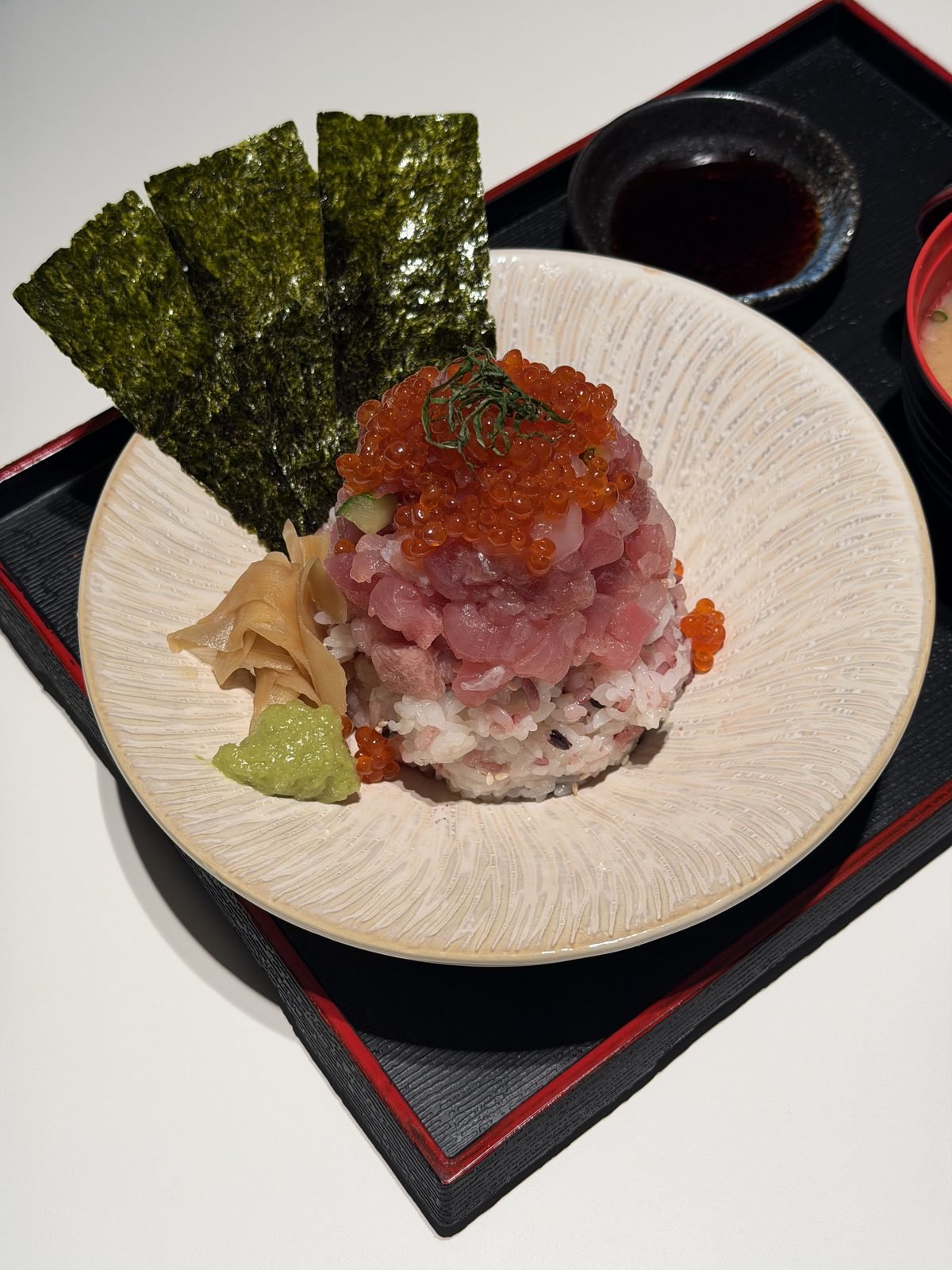 Egg yolk poured over fresh seafood and sushi rice