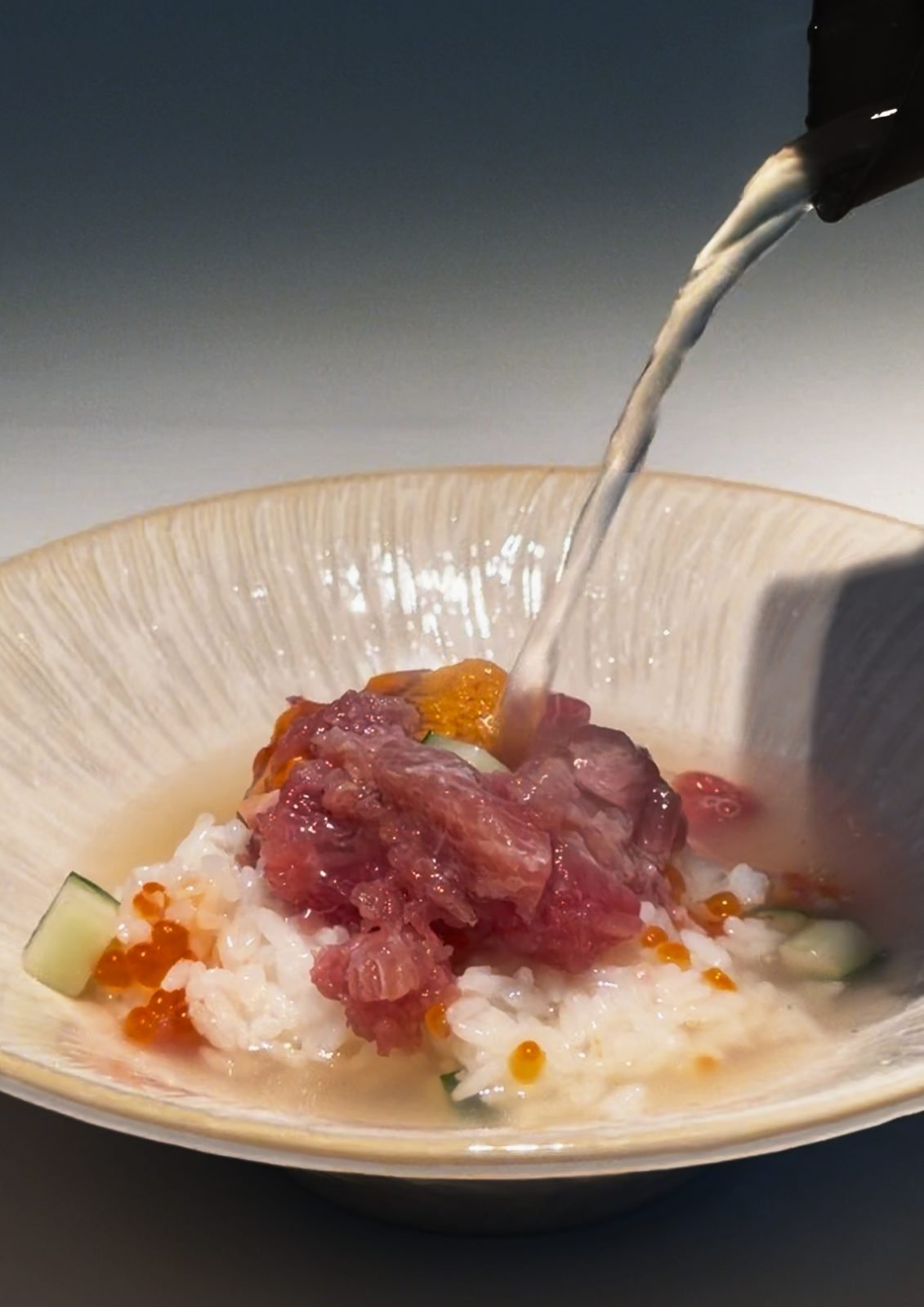 Warm dashi broth poured over the remaining rice and seafood